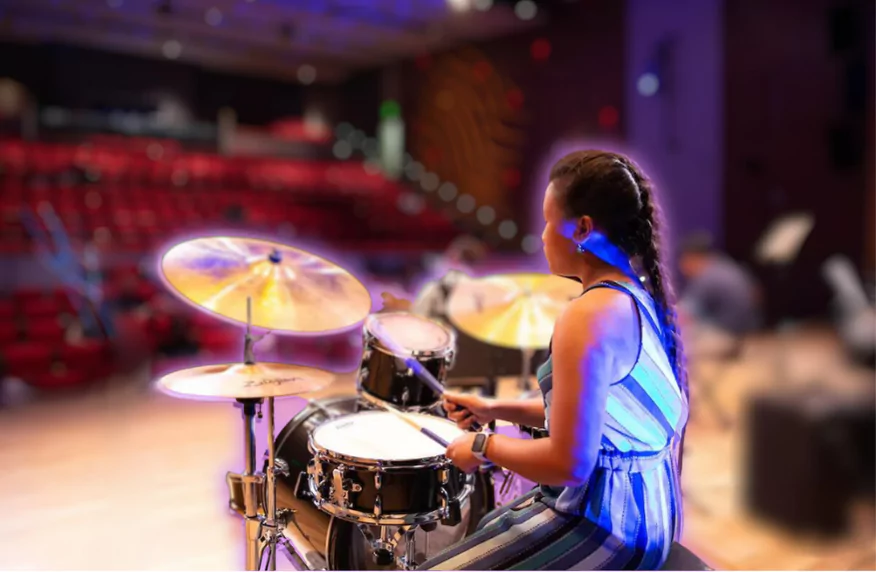 Young Girl Drummer at Texas School of Music performance. TSM offers drum lessons for all levels.